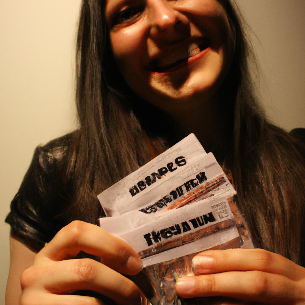 Person holding concert tickets, smiling